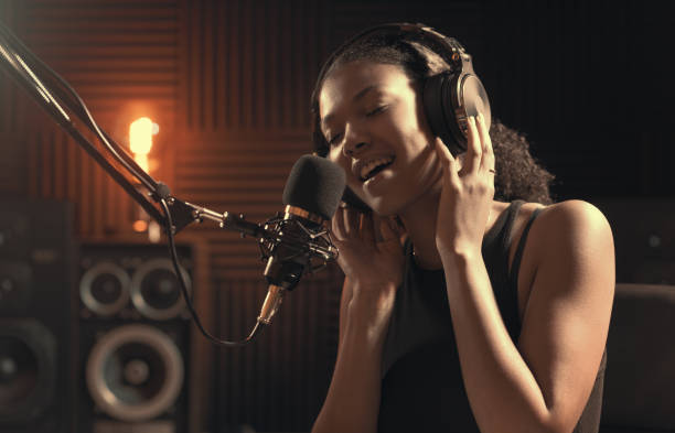 istock Woman recording an audio track in the studio 1754205465
