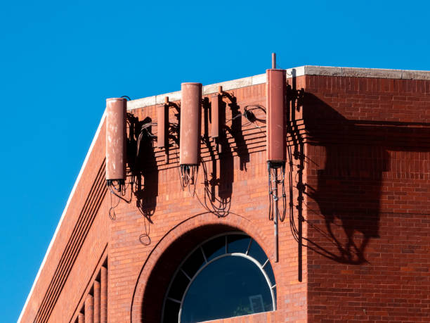 istock Camouflaged cell phone antennas on a brick building. 1754206648