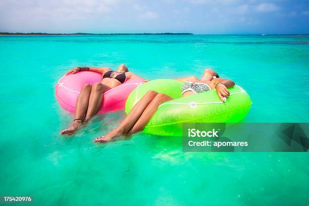 Duas Mulheres Jovens Relaxante Com Tubos Numa Praia Tropical - Fotografias de stock e mais imagens de Grupo multiétnico