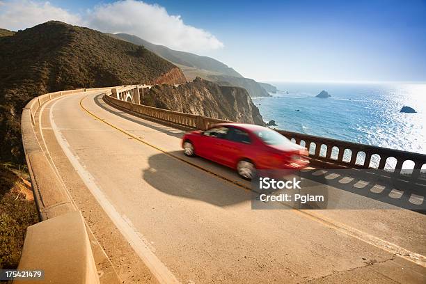 Red Car Zooms Down Bixby Bridge In Big Sur Stock Photo - Download Image Now - Car, Driving, Beach