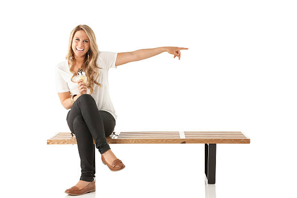 istock Happy woman eating an ice cream and pointing 175421777