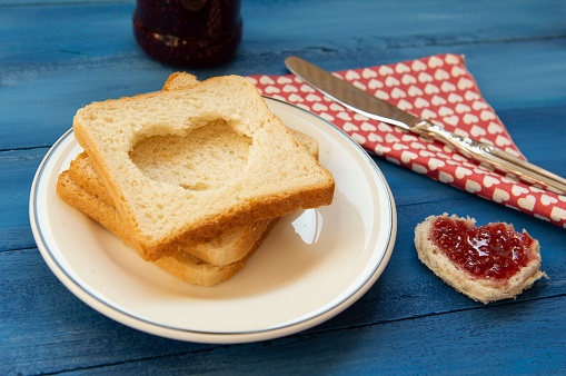 Heart of double breads and strawberry jam on square breads