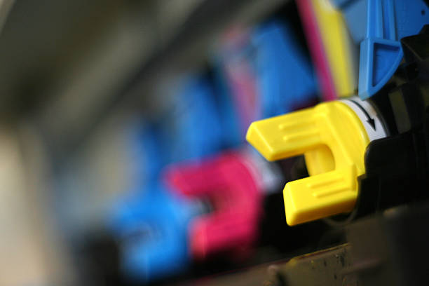 CMYK laser toner cartridges in a row in a laser printer.
