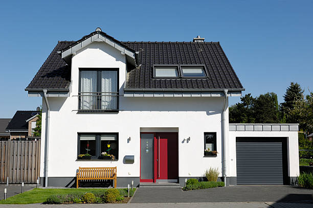 Cute one-family house with garage Typical one-familiy house. (Germany) detached house stock pictures, royalty-free photos & images