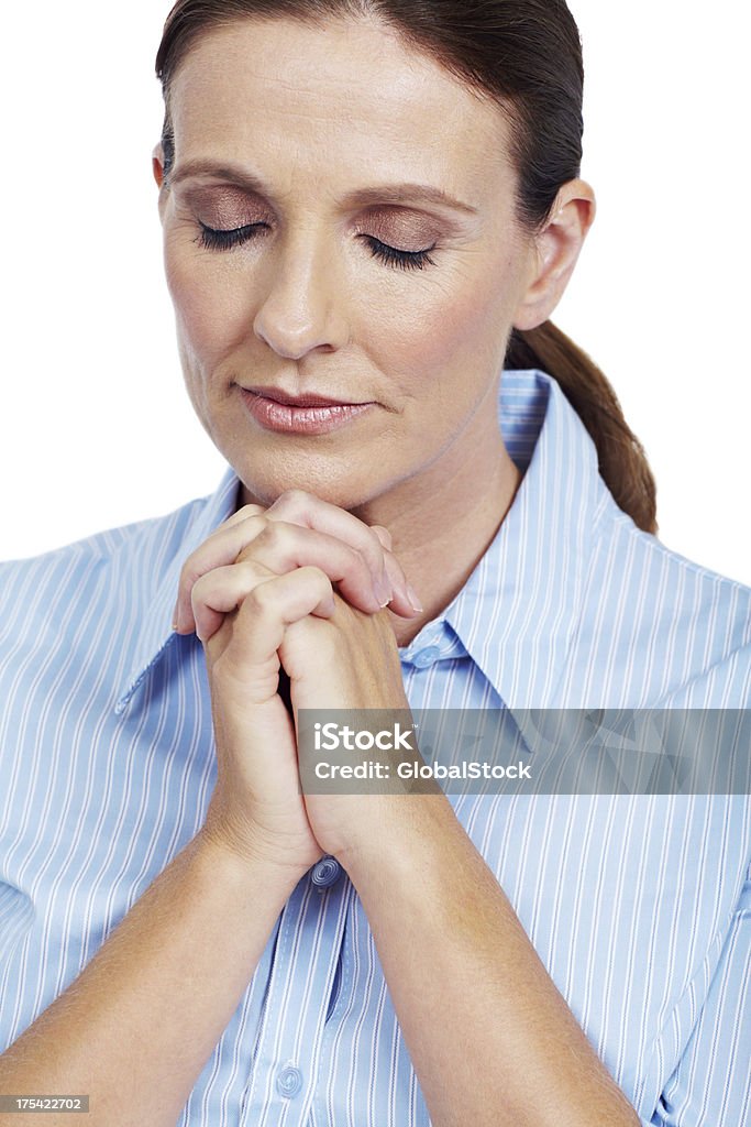 Say a little prayer Closeup portrait of a mature woman praying with her eyes closed on a white background 30-39 Years Stock Photo