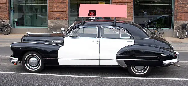 "Classic car, an ex-police vehicle now fitted with an advertising sign - blank space for your advert! Photo taken in Copenhagen, Denmark."