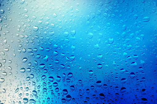 Glass wall of shower at bathroom with water drops and natural light in black and white. Photo taken August 5th, 2023, Zurich, Switzerland.