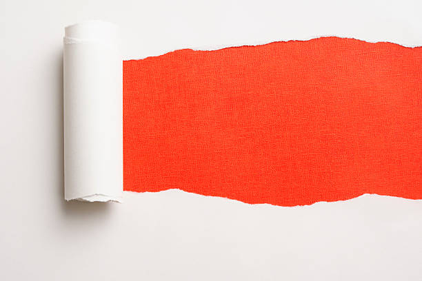 istock Close-up of white torn paper on orange background. 175423234