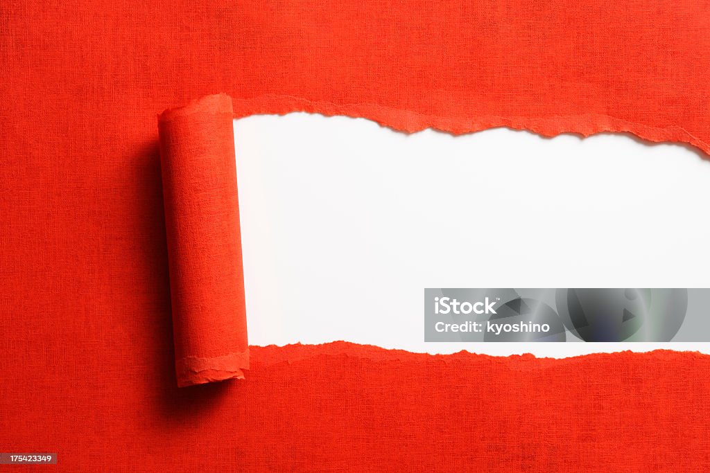 Isolated shot of torn red paper on white background Close-up of torn red paper isolated on white background. Paper Stock Photo