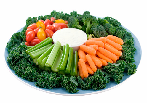 Crunchy healthy snacks set out with a tangy ranch dip.  Shallow dof.