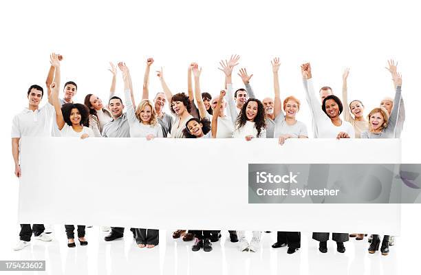 Large Group Of Happy People Holding A White Board Stock Photo - Download Image Now - Holding, People, Banner - Sign