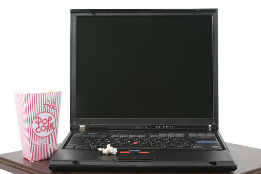 Popcorn and laptop on a white background.