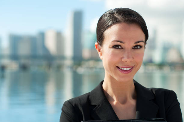 Professional businesswoman walking confidently on a city sidewalk with coffee and briefcase, smart casual, heading to work