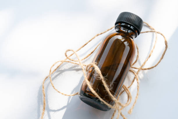 istock Mock-up Amber glass bottle on white background 1754240393