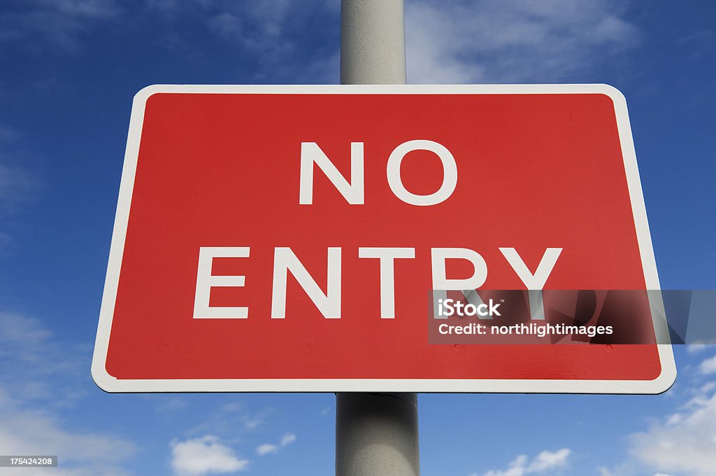 No Entry road sign Close up of a bright red No Entry sign against a clear blue sky. Blue Stock Photo