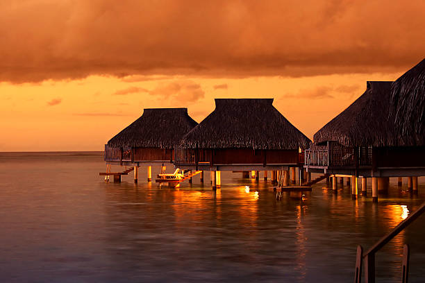 Water houses in the Tahiti Sunset stock photo