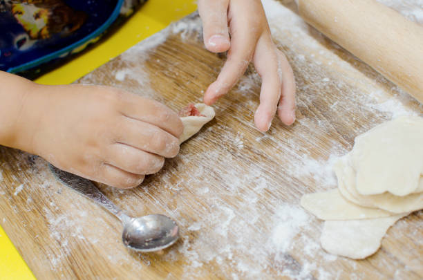 istock child makes dumplings from dough with minced meat. cooking dumplings at home 1754243493
