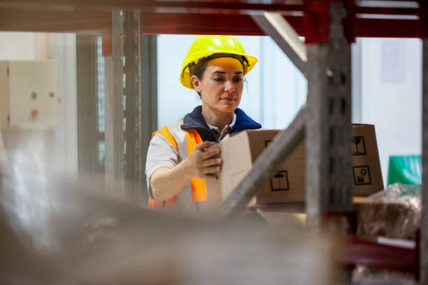 istock Female storage packer placing products on shelves in warehouse facility 1754244637