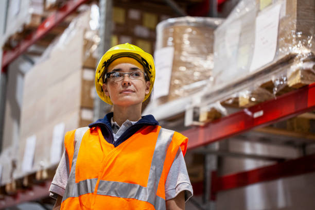 istock Female warehouse packer inspecting inventory in industrial storage facility 1754244658