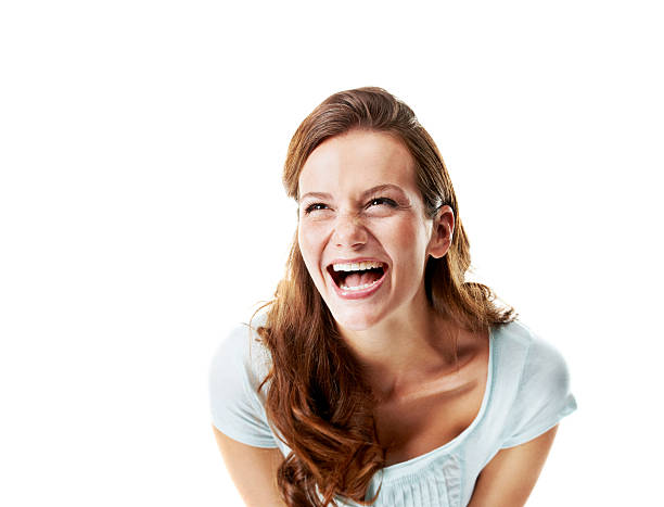 That's hilarious Pretty young woman laughing at a joke while isolated on white - Copyspace hysteria stock pictures, royalty-free photos & images