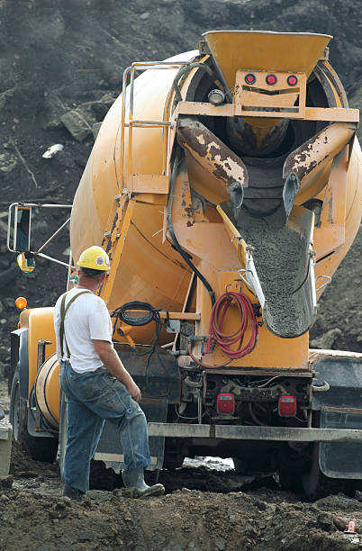 Cement truck pouring concrete at a job site. 