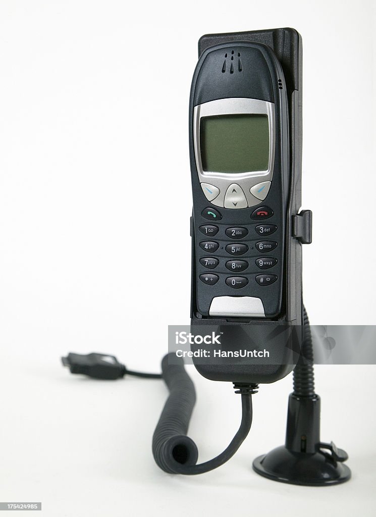 Cell phone in car holder isolated cell phone in hands-free car holder on white background Black Color Stock Photo