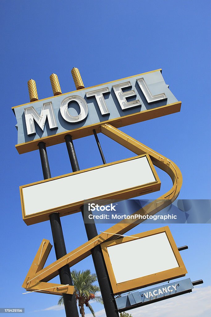 Vintage Motel Sign Angle 2 "Old yellow and blue motel sign against a cloudy blue sky. One of 4 versions on iStock. Canon 30D, 17-55mm lens." Antique Stock Photo