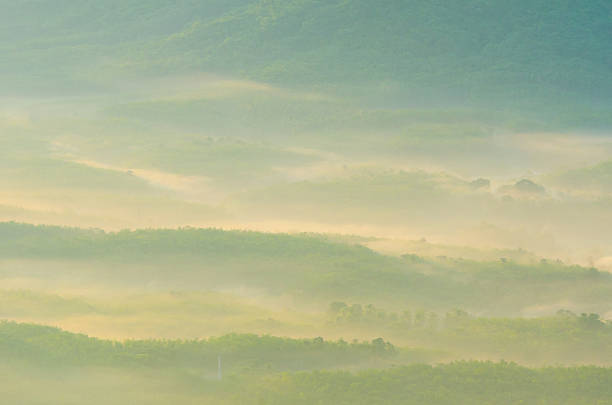 Beautiful sunrise at misty morning mountains .