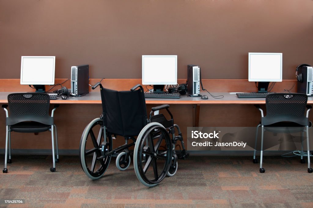 Computer Stations Wheelchair Access Empty computer stations with a wheelchair access area. Ada Township - Michigan Stock Photo