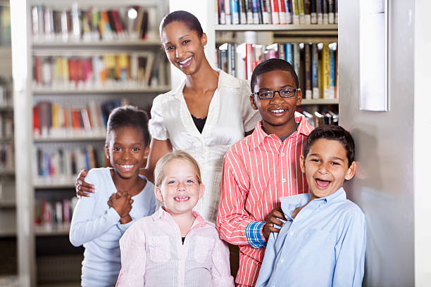 istock Children and teacher in library 175425960