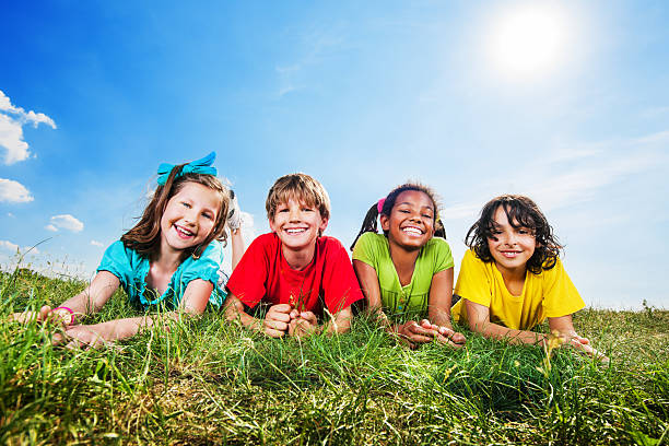 istock Happy kids lying in field and looking at camera. 175425996