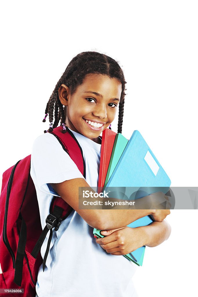 African American girl holding her notebook Smiling little girl tightly holding her notebooks and looking at the camera.  Isolated on white background. African-American Ethnicity Stock Photo