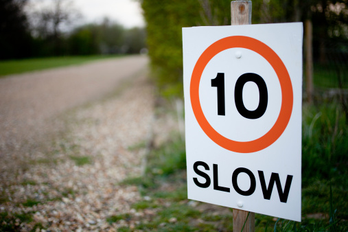 Roadside sign warning drivers to drive slow at 10 m.p.h. or slower.