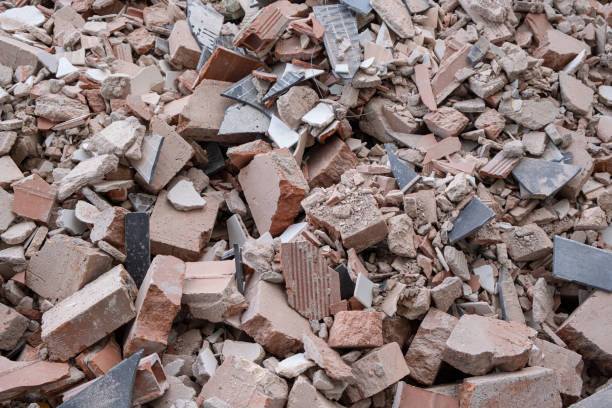 istock Shattered, broken red clay ceramic bricks, remnants of construction waste after building demolition, now laid in a construction waste container. Collection service 1754263712
