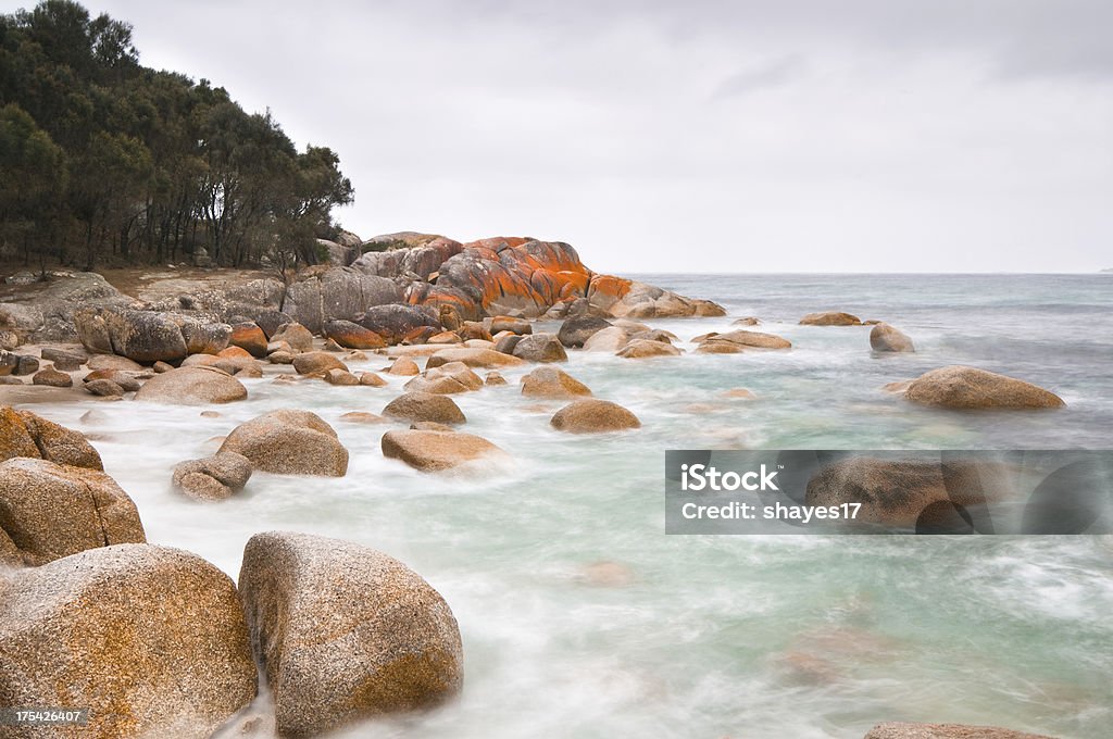 Blurred ocean seacoast "A daytime long exposre of lichen covered rocks along the Bay of Fires in Tasmania, Australia." Bay of Fires Stock Photo