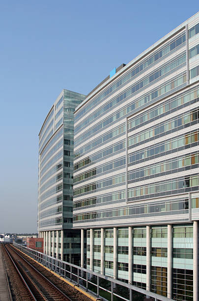 Office Building next to Railway A modern office building next to a railway. business architecture blue people stock pictures, royalty-free photos & images