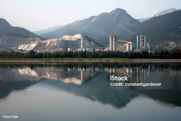 Industrial Cemento Planta Con Reflejos De Las Montañas Foto de stock y más banco de imágenes de Contaminación ambiental