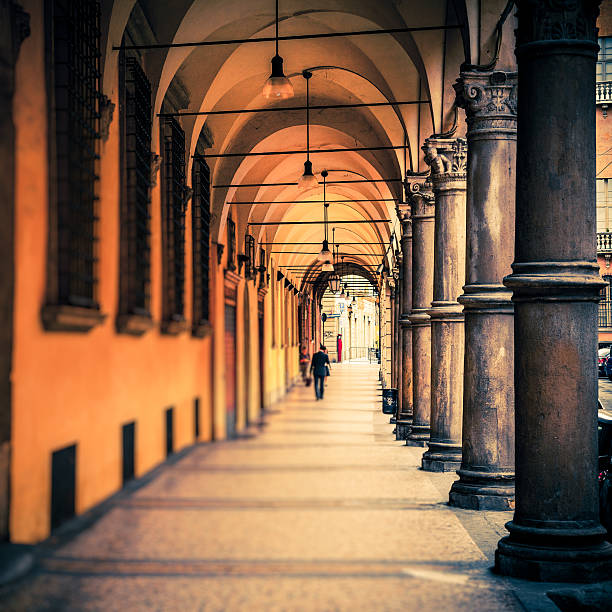 People Walking in the Streets of Bologna, Italy Typical porch on the streets of Bologna bologna photos stock pictures, royalty-free photos & images