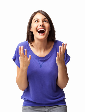 Surprised young Caucasian woman in casual wear looking up. Vertical shot. Isolated on white.