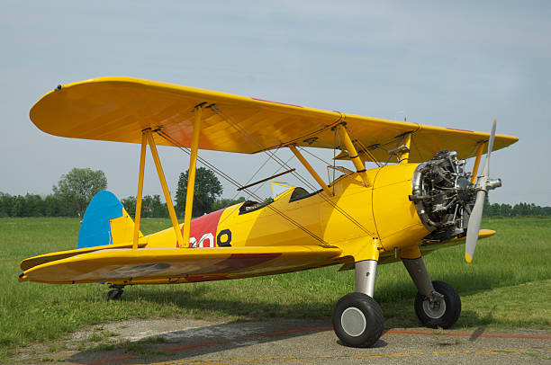 istock Vintage yellow biplane outside and ready to fly 175428099