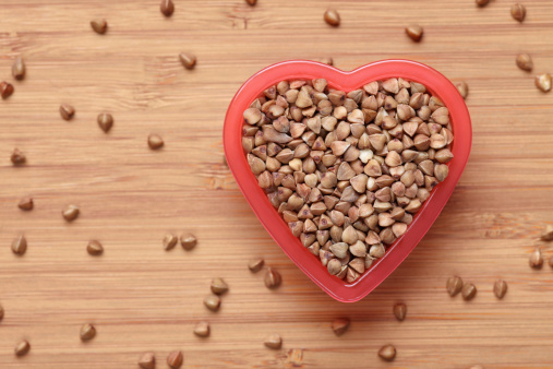 Buckwheat in a heart bowl. Close-up.Please see lightbox: