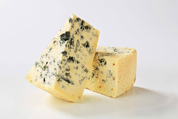 blue cheese two pieces of a ripe blue cheese portion cut out cheese part of stock pictures, royalty-free photos & images