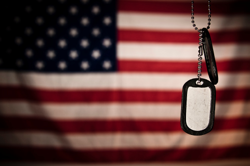 Dogtags hanging in font the flag of the United States of America.