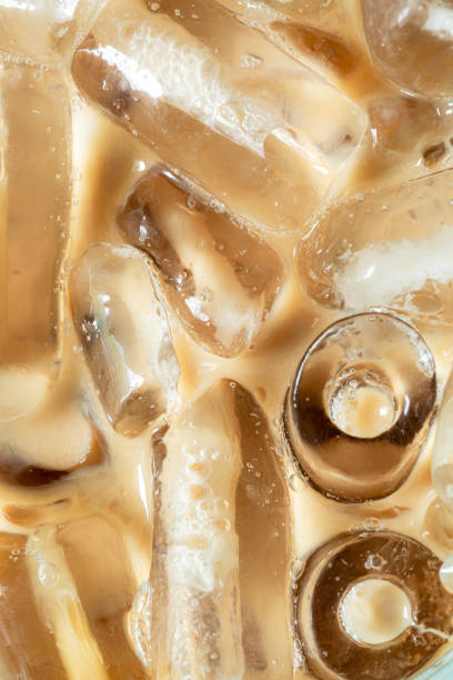 istock Coffee texture and macro ice cubes,Close-up of Cold latte drink with ice cubes 1754284547