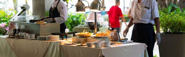 Hotel breakfast service point,Waiter posing in front of buffet in restaurant