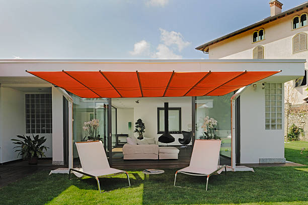 istock Parasol with deck chairs on the grass, living-room on background 175428729