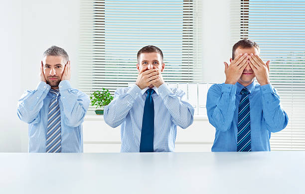Three wise monkey - business concept "Three businessmen posing like three wise monkeys: hear no evil, speak no evil, see no evil." serious monkey stock pictures, royalty-free photos & images