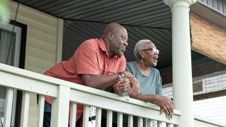 Retired Black seniors admiring view from their veranda