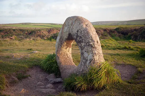 "A rare holed stone, called Men-an-Tol stands in a moor in the Cornish countryside."