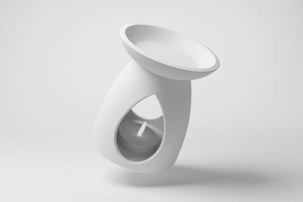 istock Oil burner with an ignited candle inside floating in mid air on white background in monochrome and minimalism. Illustration of the concept of aromatherapy 1754302057